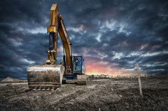 Trucks - Excavator machinery at construction site, sunset in background