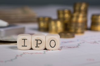 IPO 7 - IPO composed of wooden letters with stacks of coins in the background