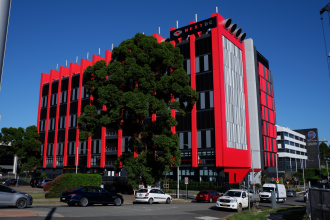 Macquarie Park NSW Australia March 5th 2021: The new Next DC Data storage technology building is a striking modern design with a bright red and silver fasade.