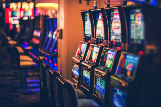 Pokies machines lined up in a row in an unknown location at a casino-like venue