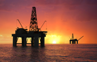 Oil - Oil rig silhouette over orange sky