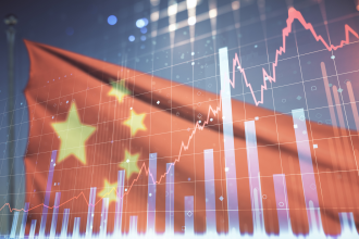 Bar graphs and a line chart in the foreground of a Chinese flag 