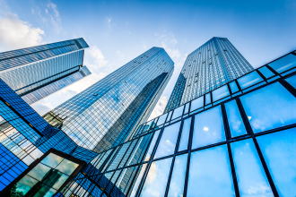 Bottom view of modern skyscrapers in business district against blue sky office