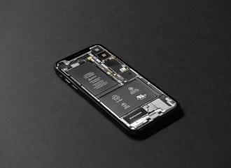 A smartphone with its back casing removed and batteries visible; supercapacitors may be used in phones in the near future