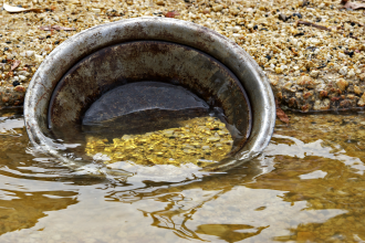 Gold exploration pan in river. This was the method used to collect gold by many surface-level prospectors in the historical gold rush era in Australia 