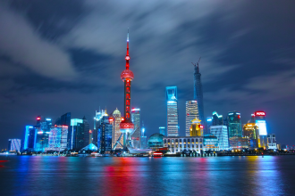 The Shanghai city skyline lit up in evening