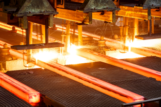 Hot steel on conveyor belt in steel mill factory