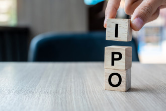 IPO 12 - Businessman hand holding IPO (Initial Public Offering) word with wooden cube block