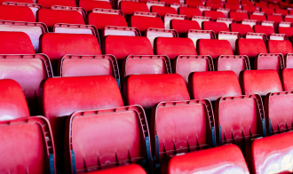 Red plastic empty stadium seats
