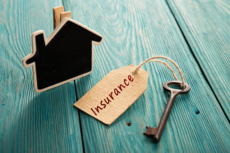 Insurance - home insurance concept - little house and old key