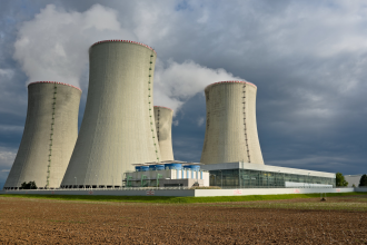 A photograph of four nuclear reactor vent towers at a facility in the Czech Republic
