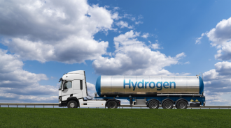 A tanker sits on the back of a truck with the words Hydrogen painted longways across it in blue 
