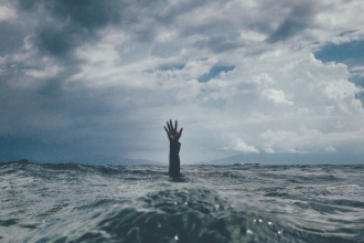 drowning in ocean with hand up for help