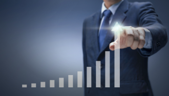 Businessman pointing to a stock graph with high rate of growth