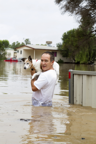 Man holding dog in flood