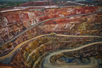 Trucks - Yellow truck drives along a winding path inside an open cast mine in New South Wales, Australia