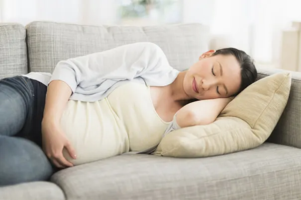 Mujer embarazada durmiendo de medio lado