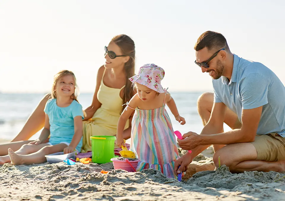 Familia jugando en la playa. Actividades para niños de 2 a 3 años