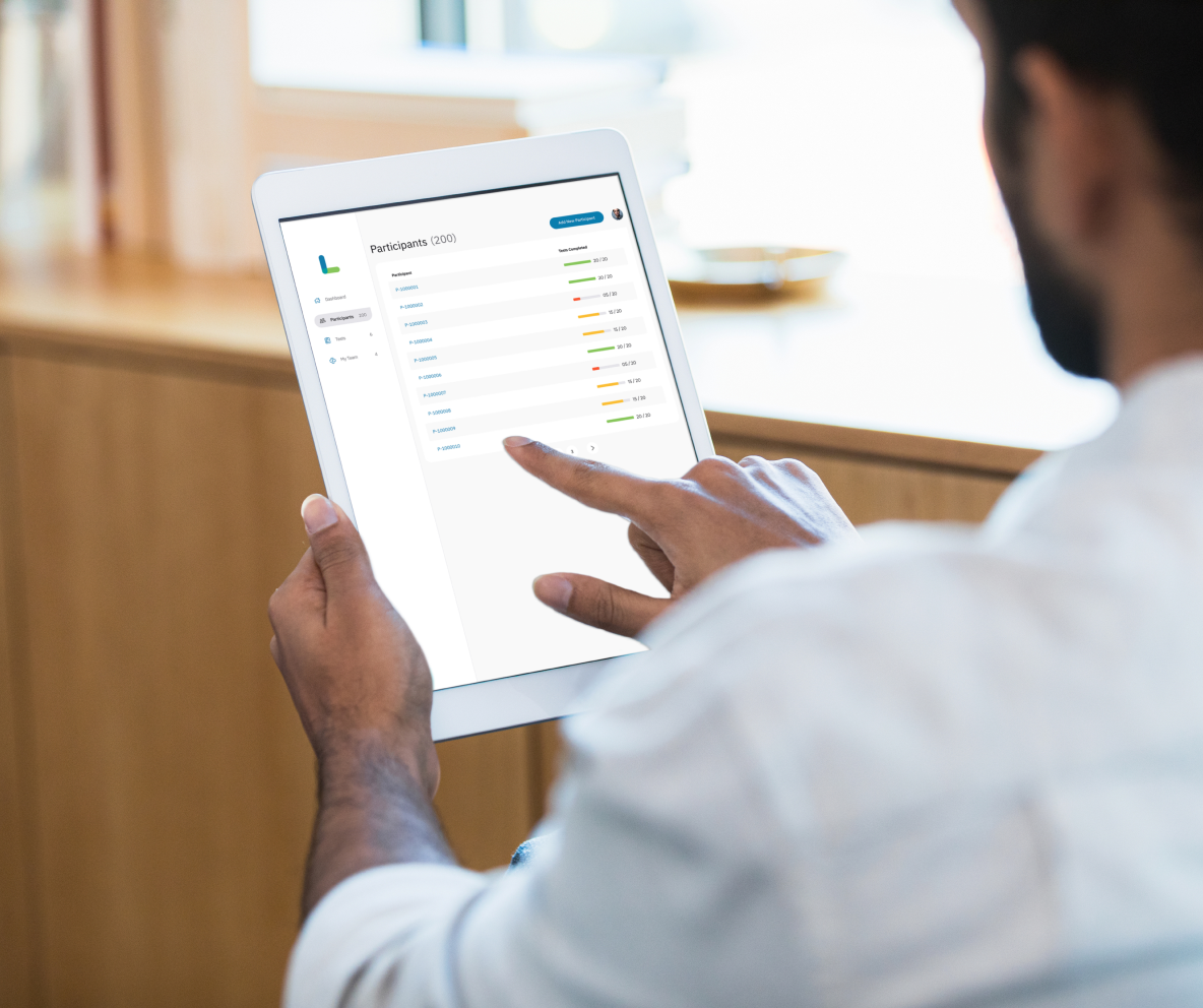 Research reviews participant list on digital tablet screen