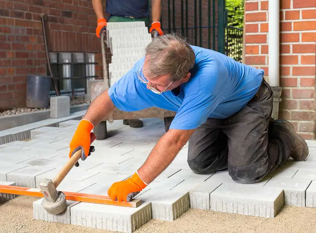 Tradesperson laying new patio