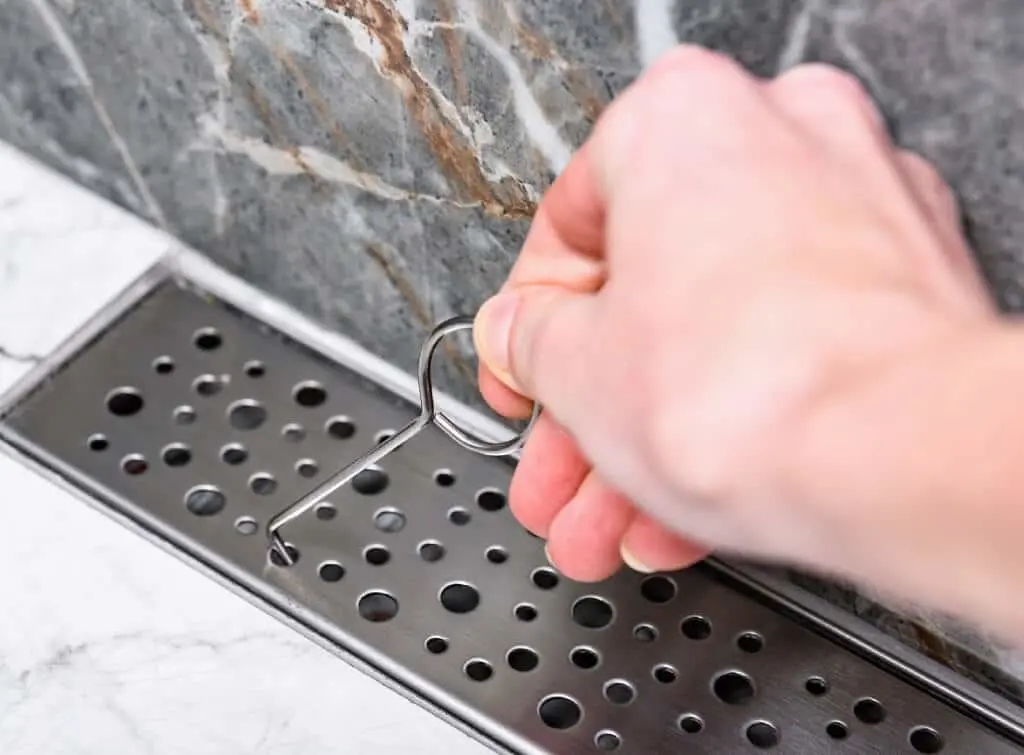 How to remove a shower drain cover