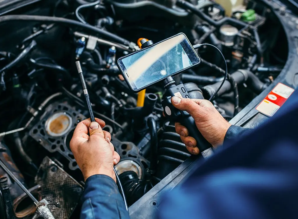 Mobile mechanic repairing a car