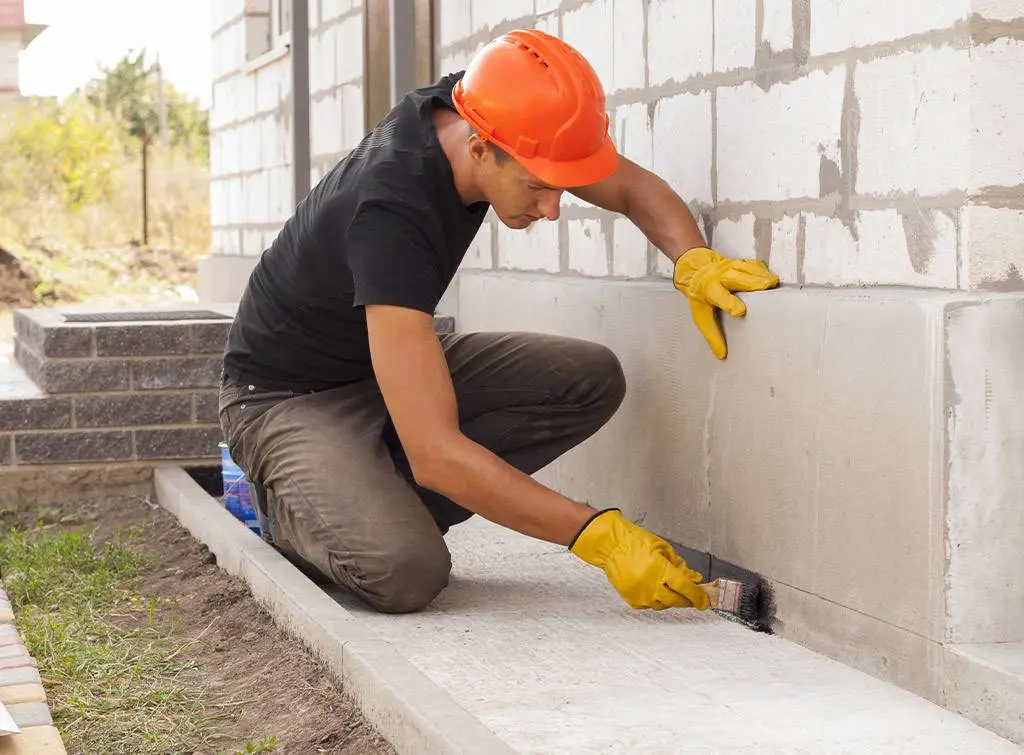 Damp proofing contractor treating a wall for damp