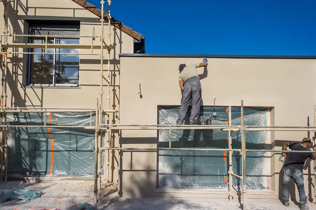 Rendering contractor applying a textured finish to a wall