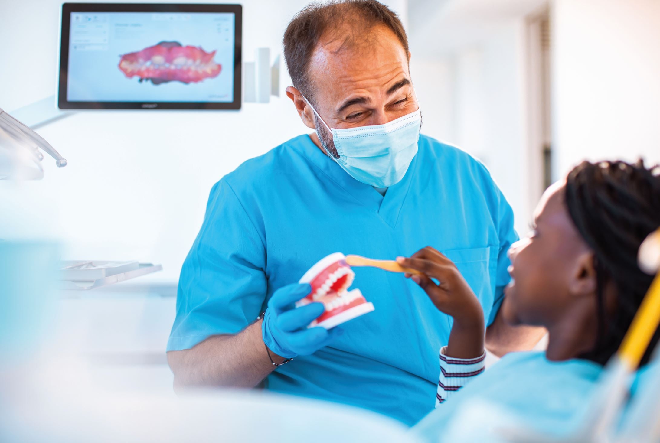 Dentist helping patient understand dental health