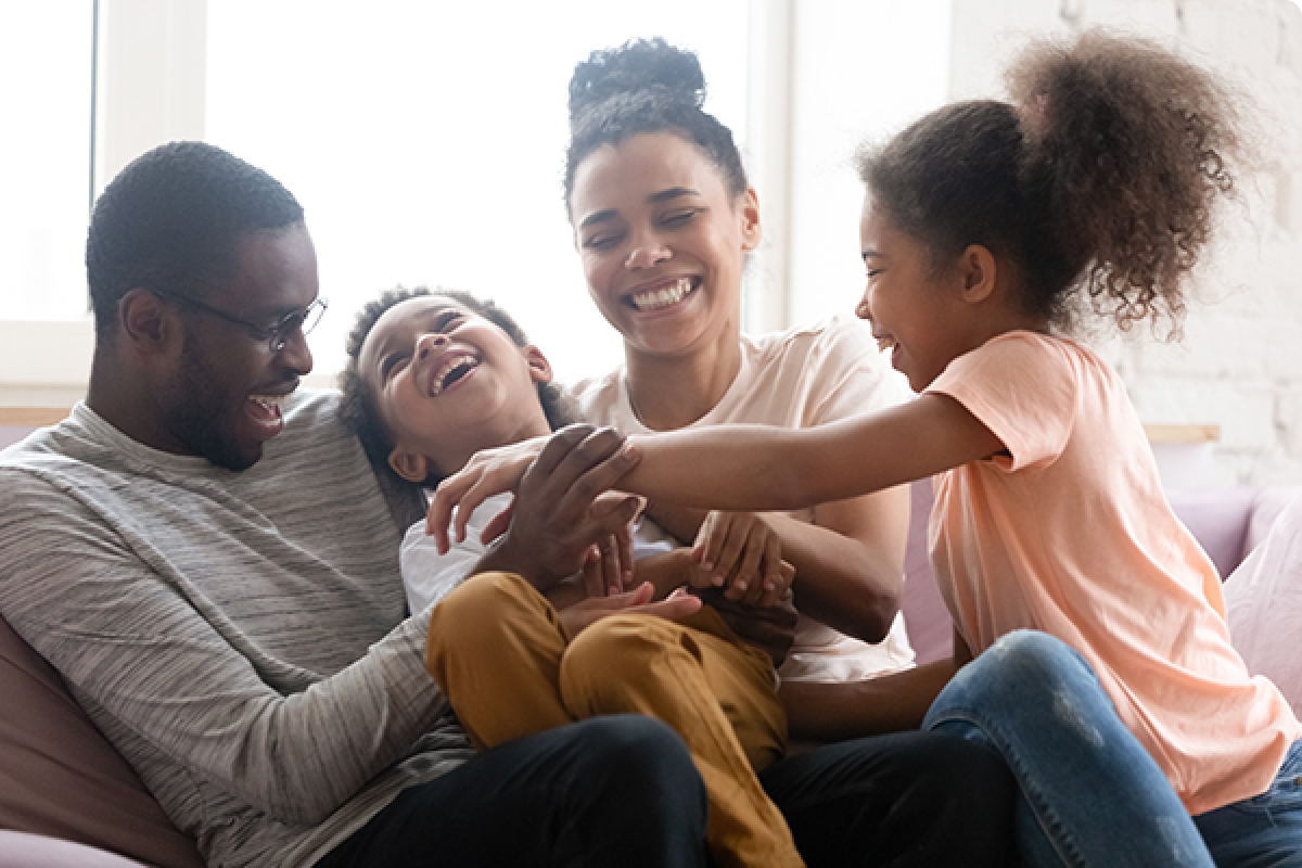 Family tickling child