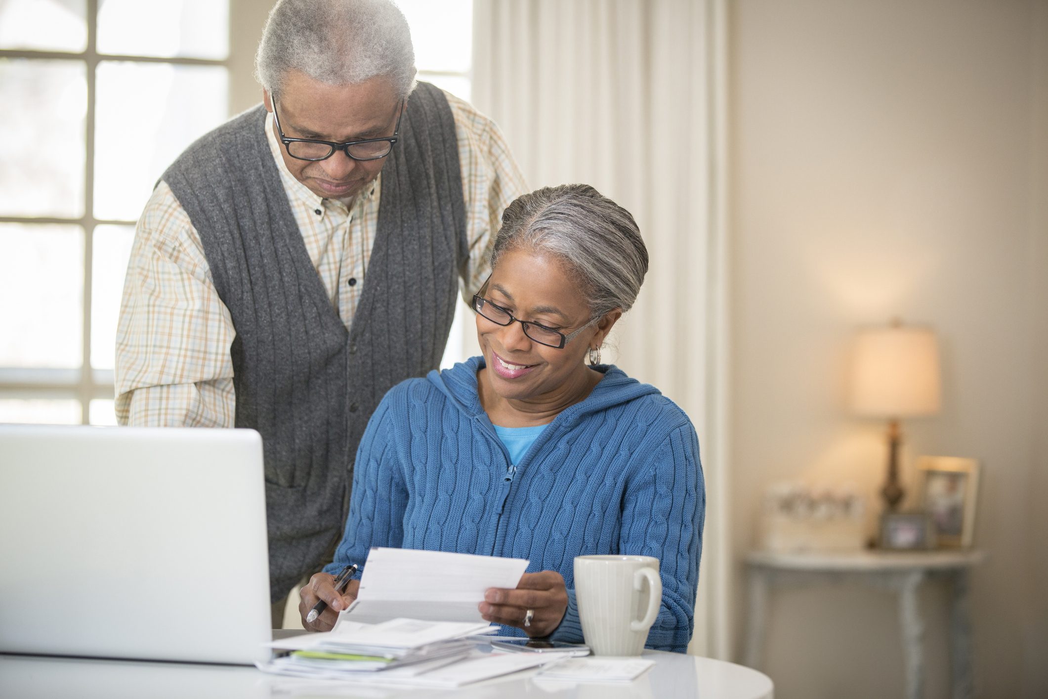Senior couple holding papers