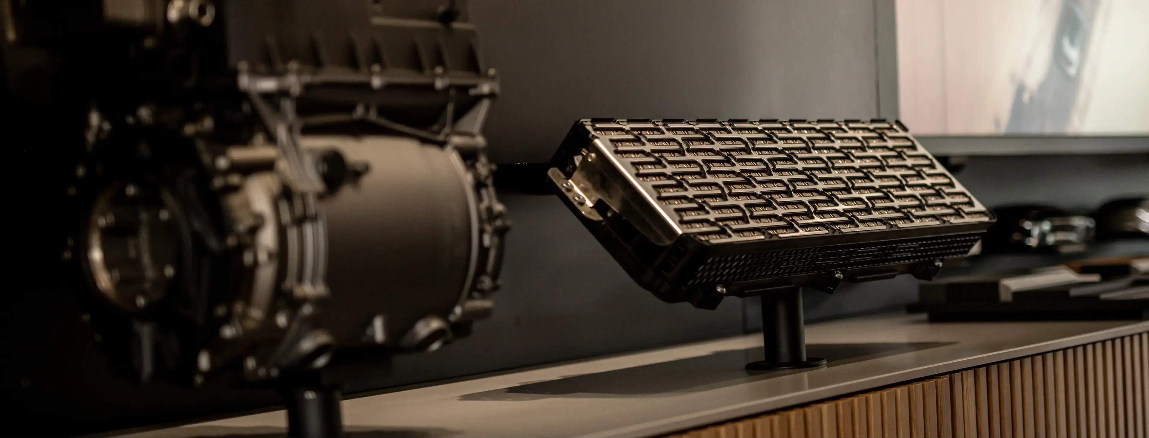 Lucid Air Battery display showing advanced electric vehicle battery system with descriptive text and technical components on exhibit.