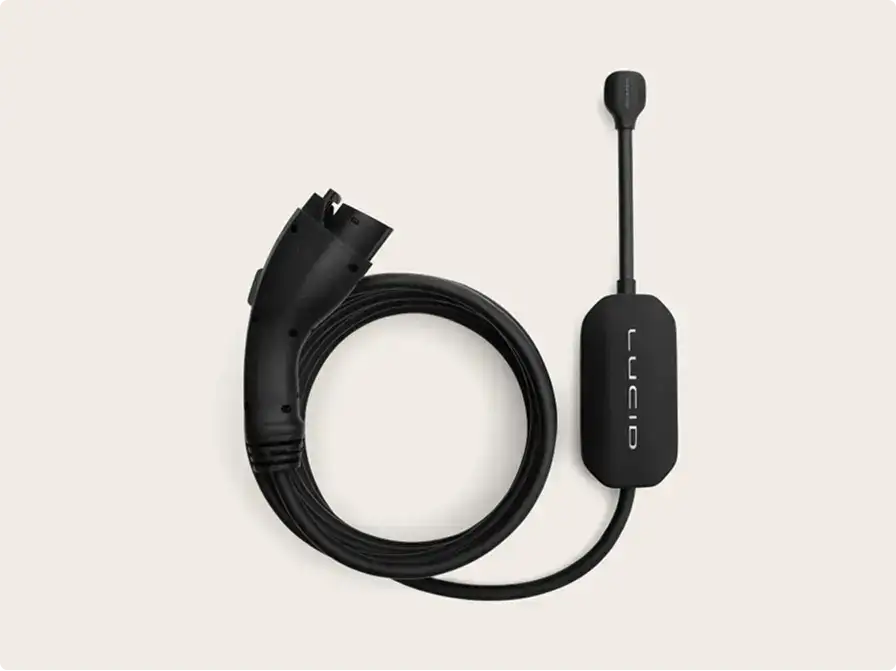 Black Lucid-branded EV charging cable coiled neatly, with a connector plug and inline control unit on a light background.