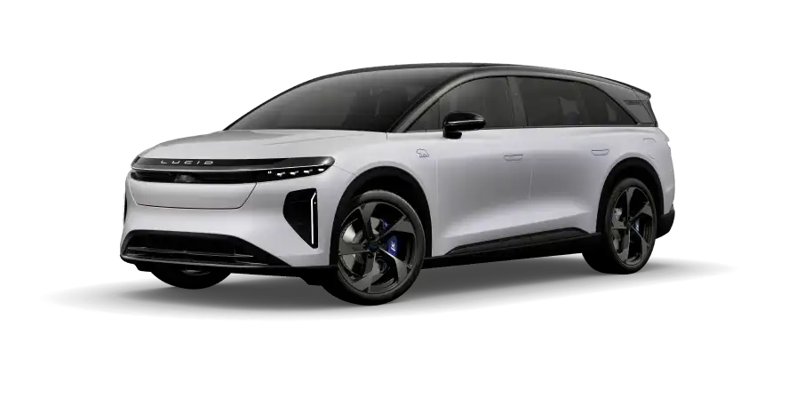 White Lucid electric SUV with dark roof, sleek LED headlights, and dark alloy wheels on a white background.