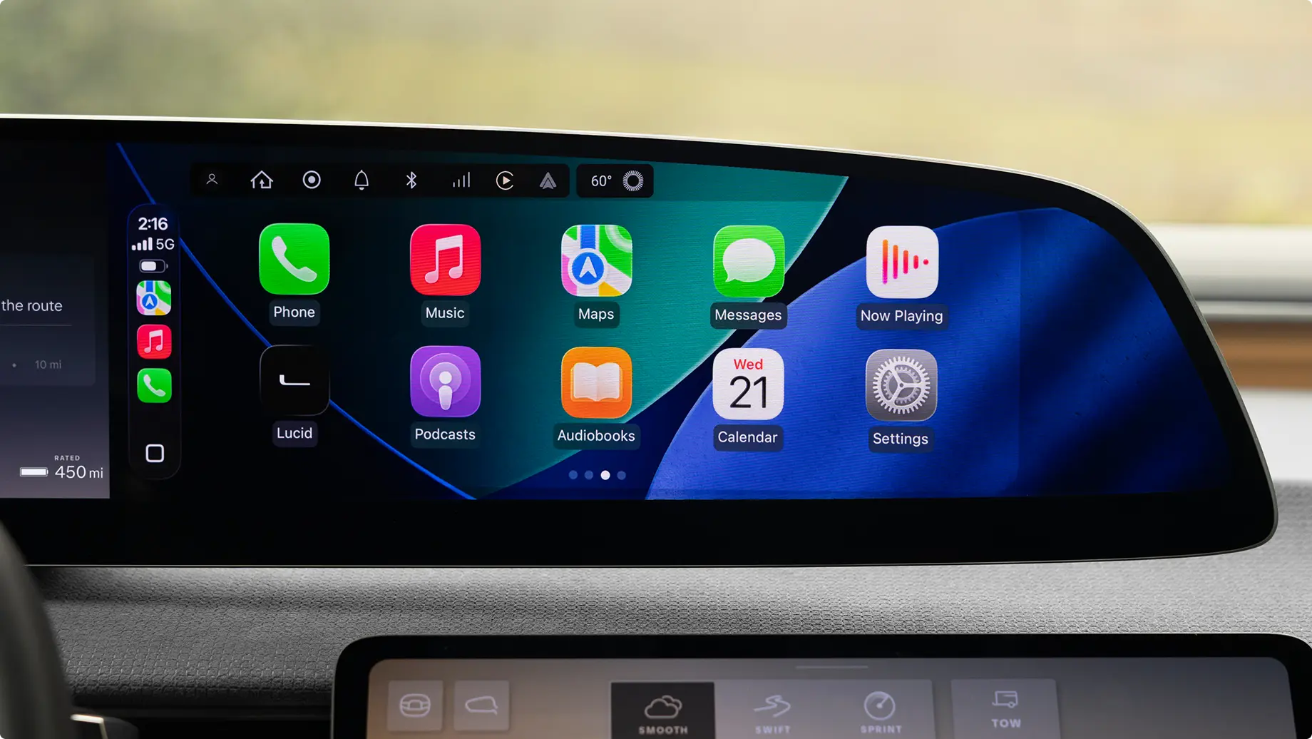 Car dashboard display showing Apple CarPlay interface with app icons including Phone, Music, Maps and Calendar showing Wed 21.