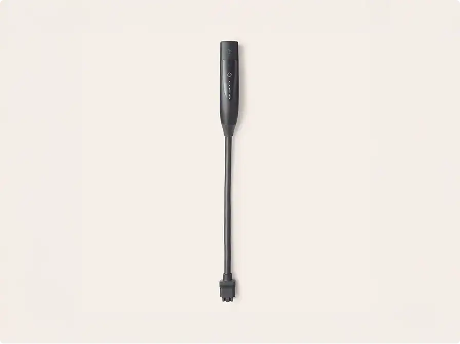 Sleek black handheld vacuum attachment with long narrow nozzle for cleaning tight spaces against cream background.