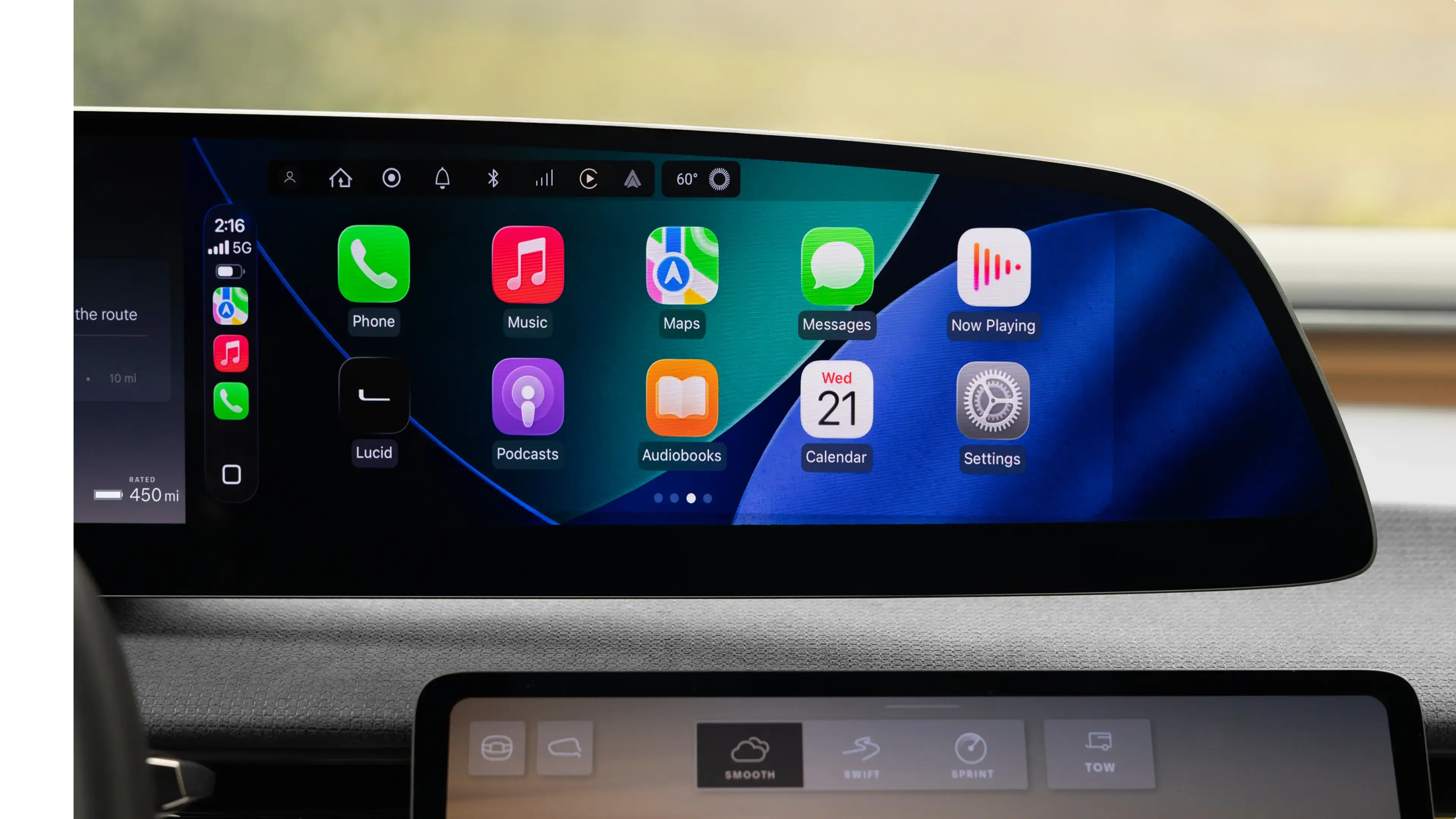 Car dashboard display showing Apple CarPlay interface with apps including Phone, Music, Maps and Calendar showing Wednesday 21st.