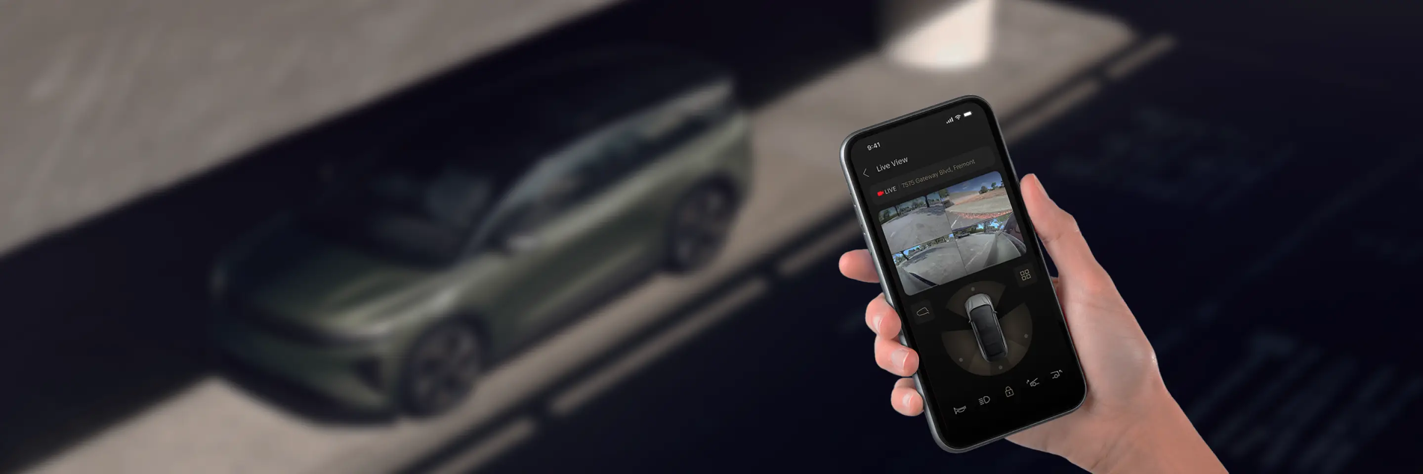 Hand holding smartphone displaying live security camera views of a vehicle with multiple camera angles visible.