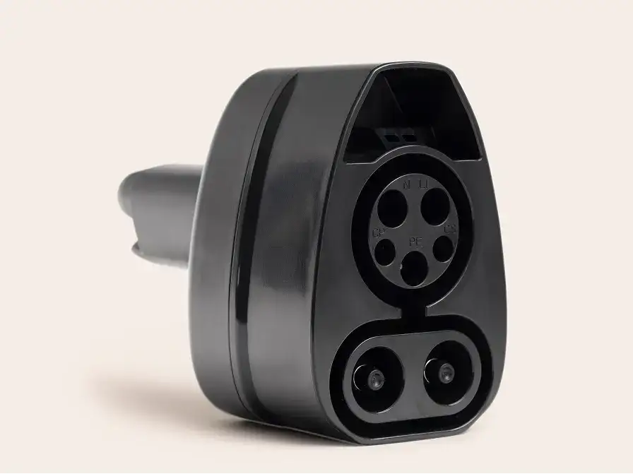 CCS1-to-NACS charging connector with multiple ports showing the socket interface against neutral background.