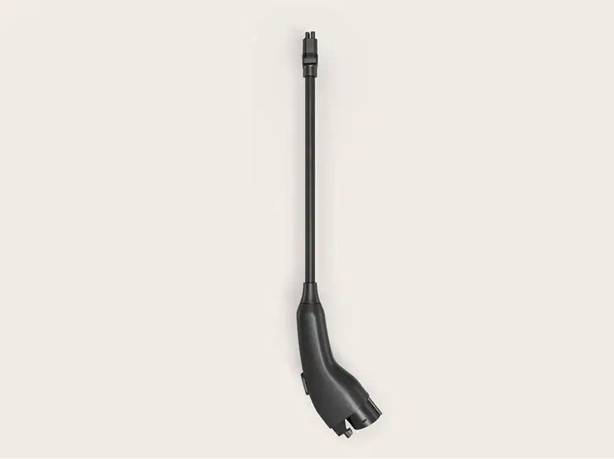 Black EV charging cable handle with a long flexible neck and connector tip, shown against a light beige background.