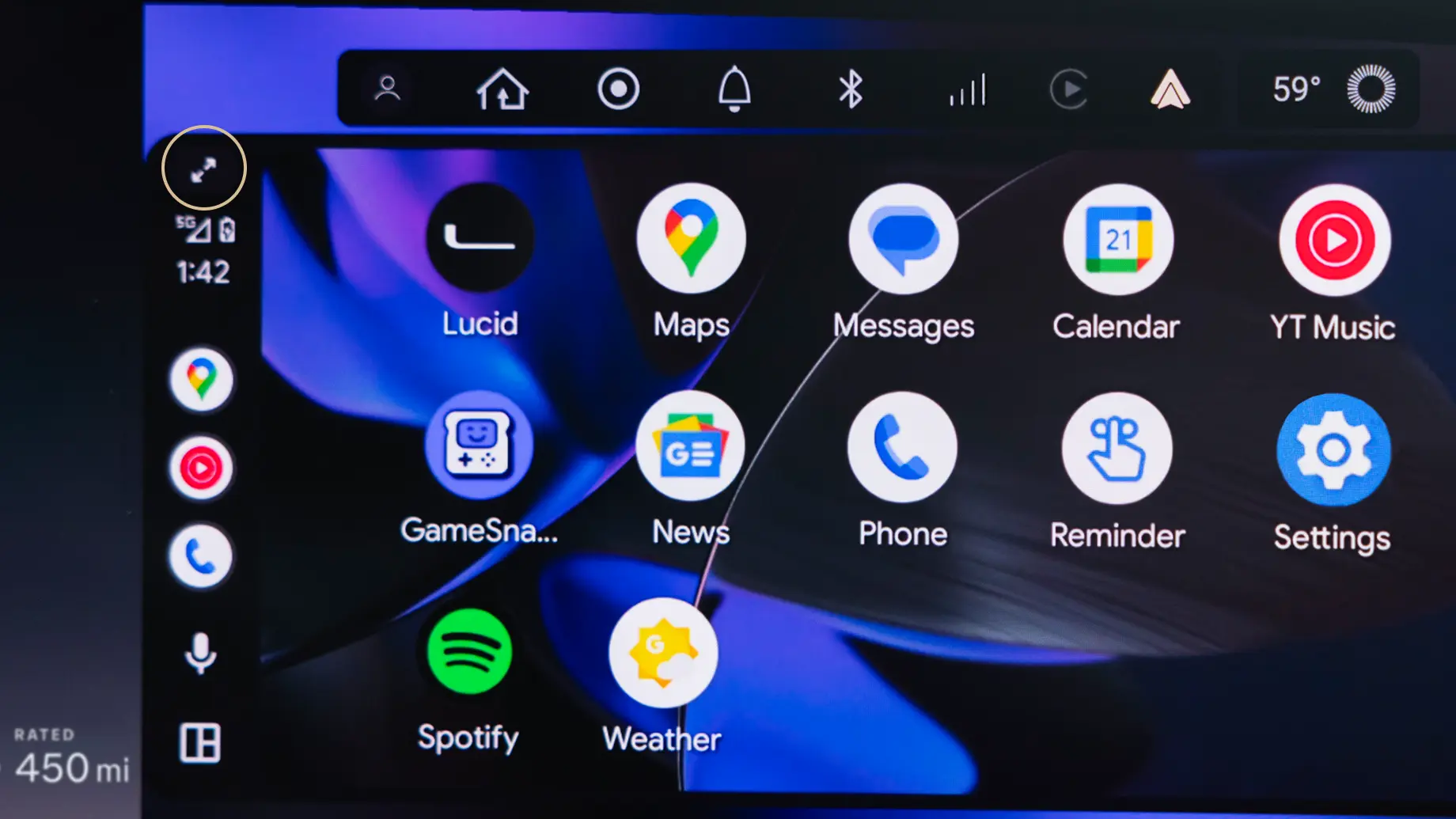 Car infotainment system displaying apps including Maps, Messages, Calendar, and Spotify on a blue background interface.