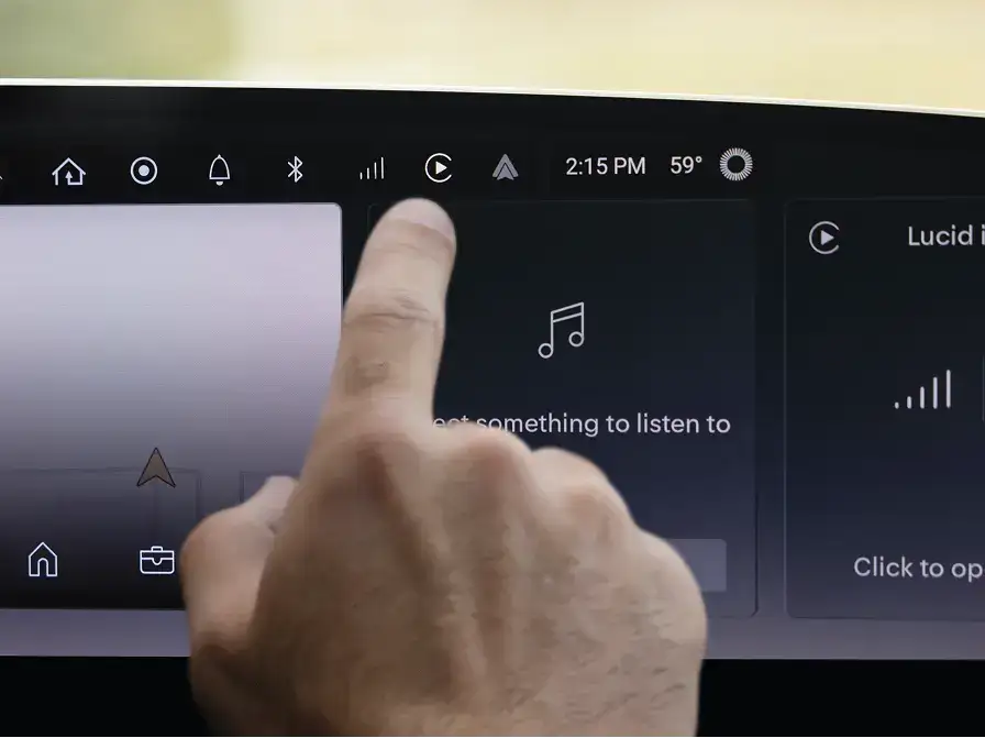 Finger touching a car dashboard screen showing music interface with note icon and "Get something to listen to" text at 2:15 PM.