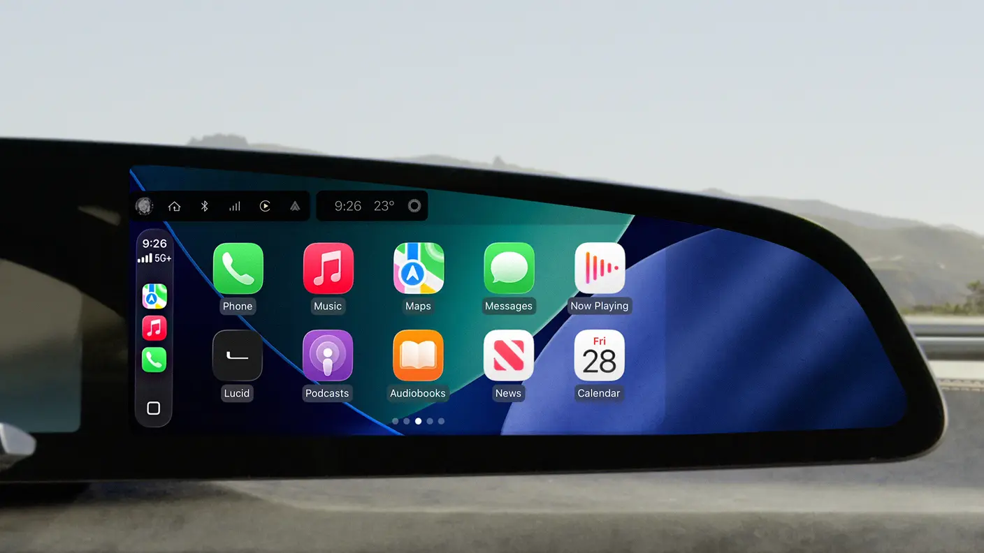 Apple CarPlay interface on a car's widescreen display showing app icons including Phone, Music, Maps, Messages, and Calendar.