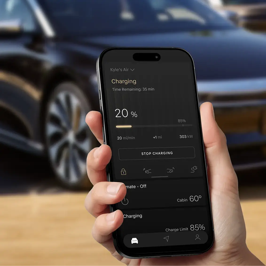 Hand holding smartphone displaying electric vehicle charging app at 20% with 35 minutes remaining, car visible in background.