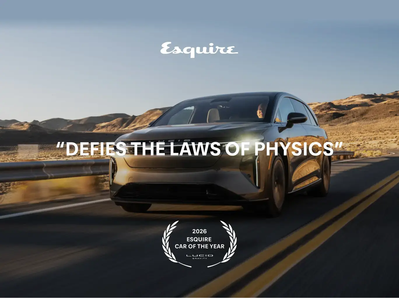 Sleek Lucid electric car driving on desert road with Esquire's 2026 Car of the Year award and "Defies the Laws of Physics" tagline.