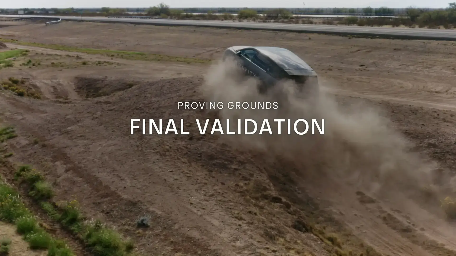 Vehicle kicking up dust on off-road proving grounds with text overlay reading "PROVING GROUNDS FINAL VALIDATION"