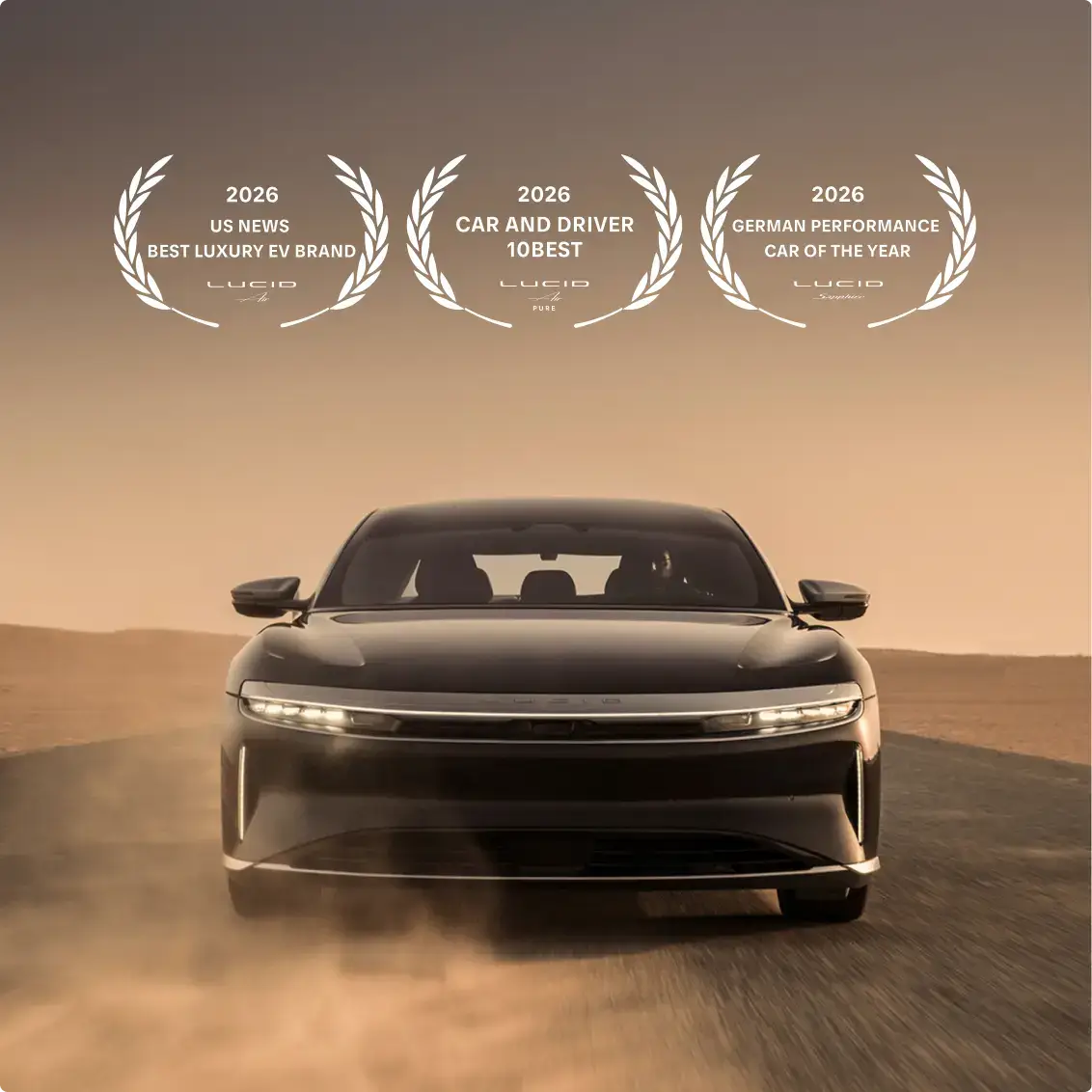 Lucid electric vehicle driving on desert road with three 2026 award emblems displayed above for luxury and performance.