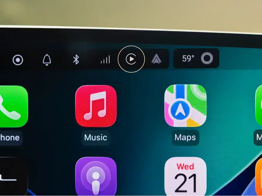 Car dashboard display showing Apple CarPlay interface with Phone, Music, and Maps apps, temperature at 59°.