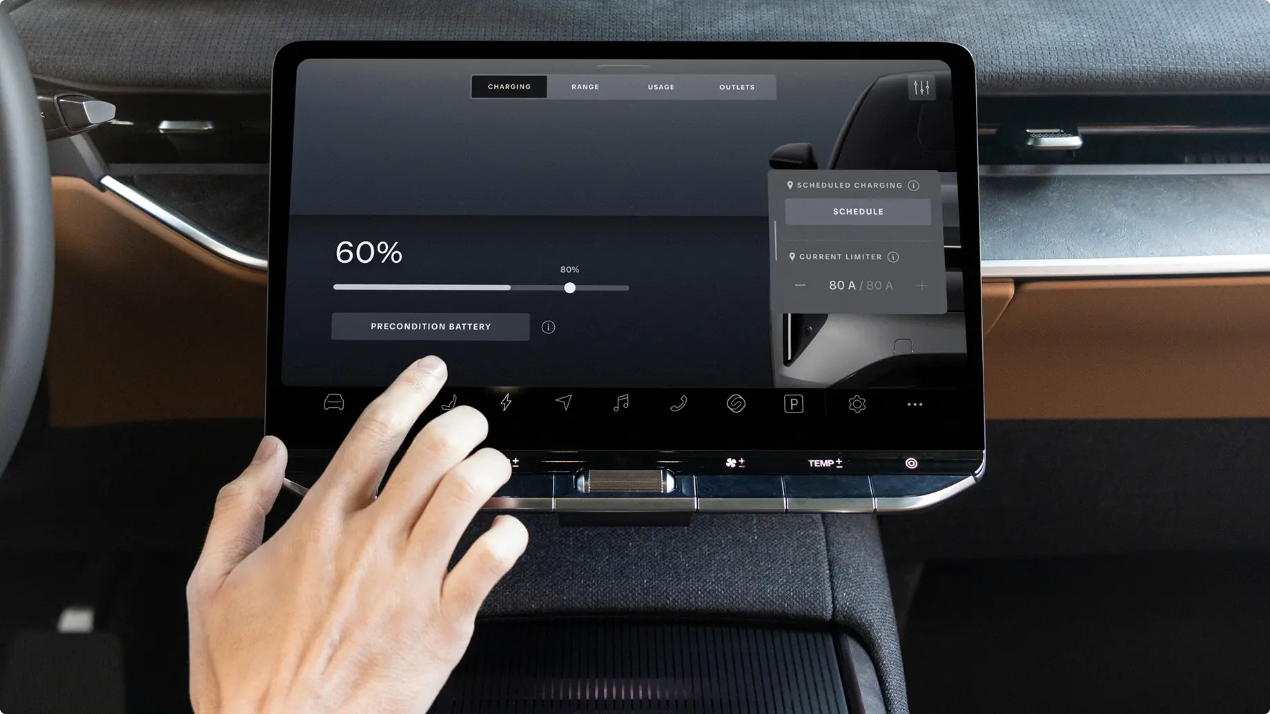 Hand touching car dashboard display showing 60% battery charge with charging settings and vehicle controls visible.