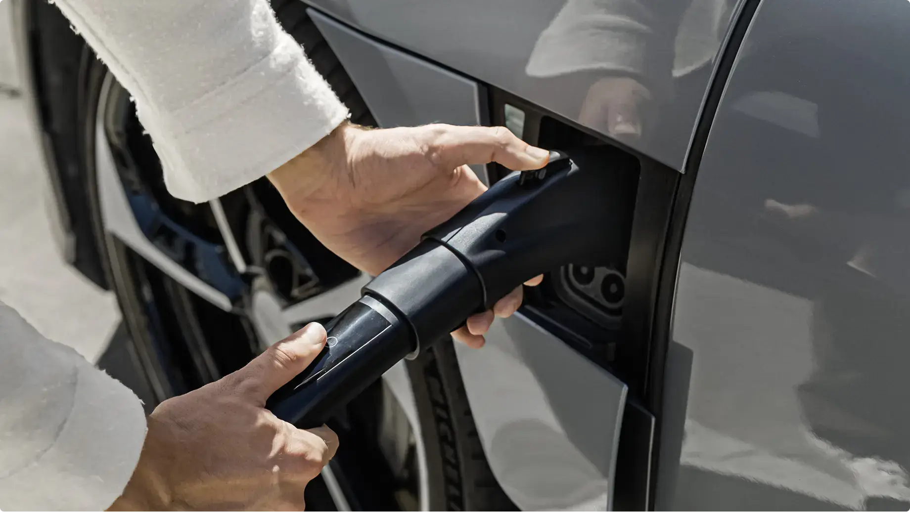 Open the charge port door of your Lucid Air and insert the charging connector with the adapter connected into the charge port.